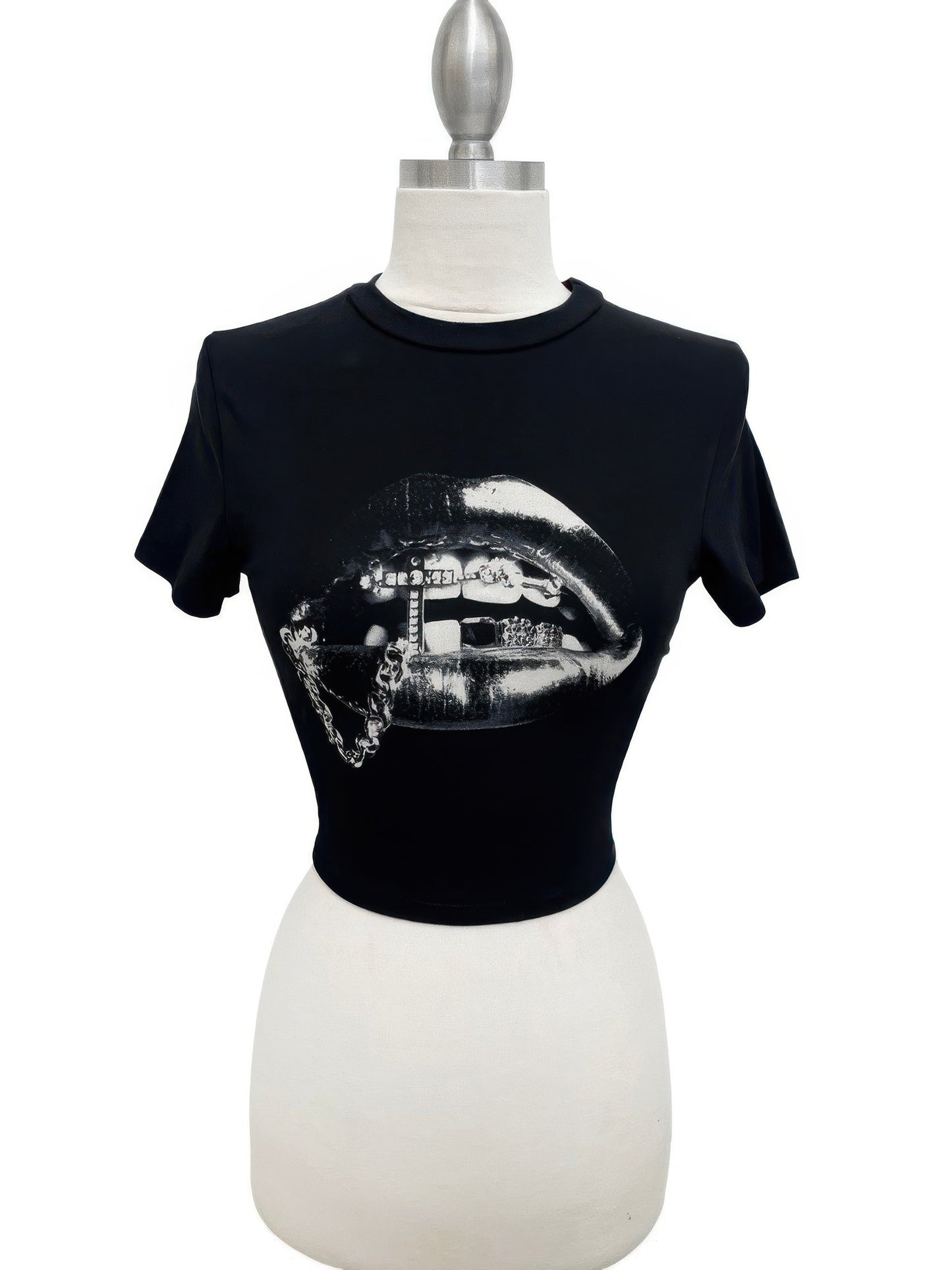 Alt Tag: Graphic Lips Crop Top black cropped tee with metallic silver lips graphic, short sleeves and crew neckline on mannequin