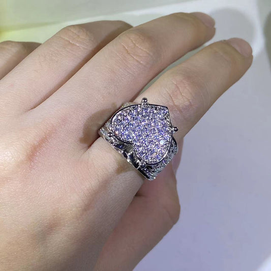 Heart-shaped zircon ring featuring prong setting on a silver band, gleaming with sparkling zircon stones.