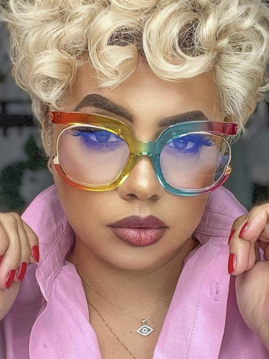 Oversized blue light filtering sunglasses in a bold colorway worn by a model with curly hair, showcasing modern eyewear style.