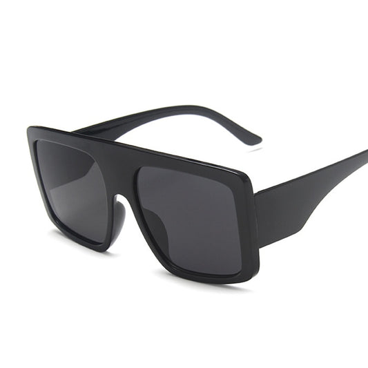 Stylish fashion sunglasses with UV protection featuring a sleek black frame and wide lenses.