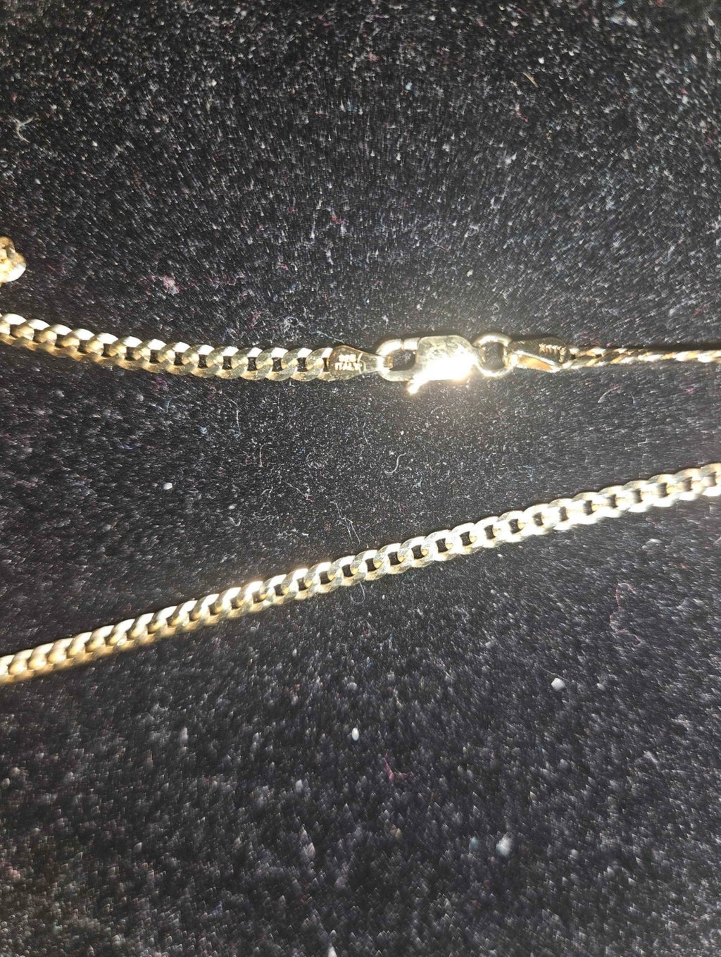 NBA moissanite pendant chain close-up showing gold over sterling silver clasp and chain details.
