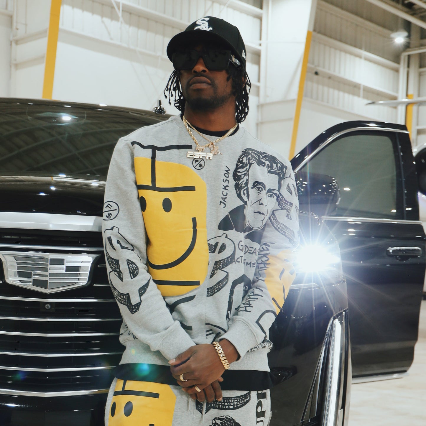 Model wearing a graphic statement sweater with bold street-inspired print, showcasing relaxed fit and unique artwork.