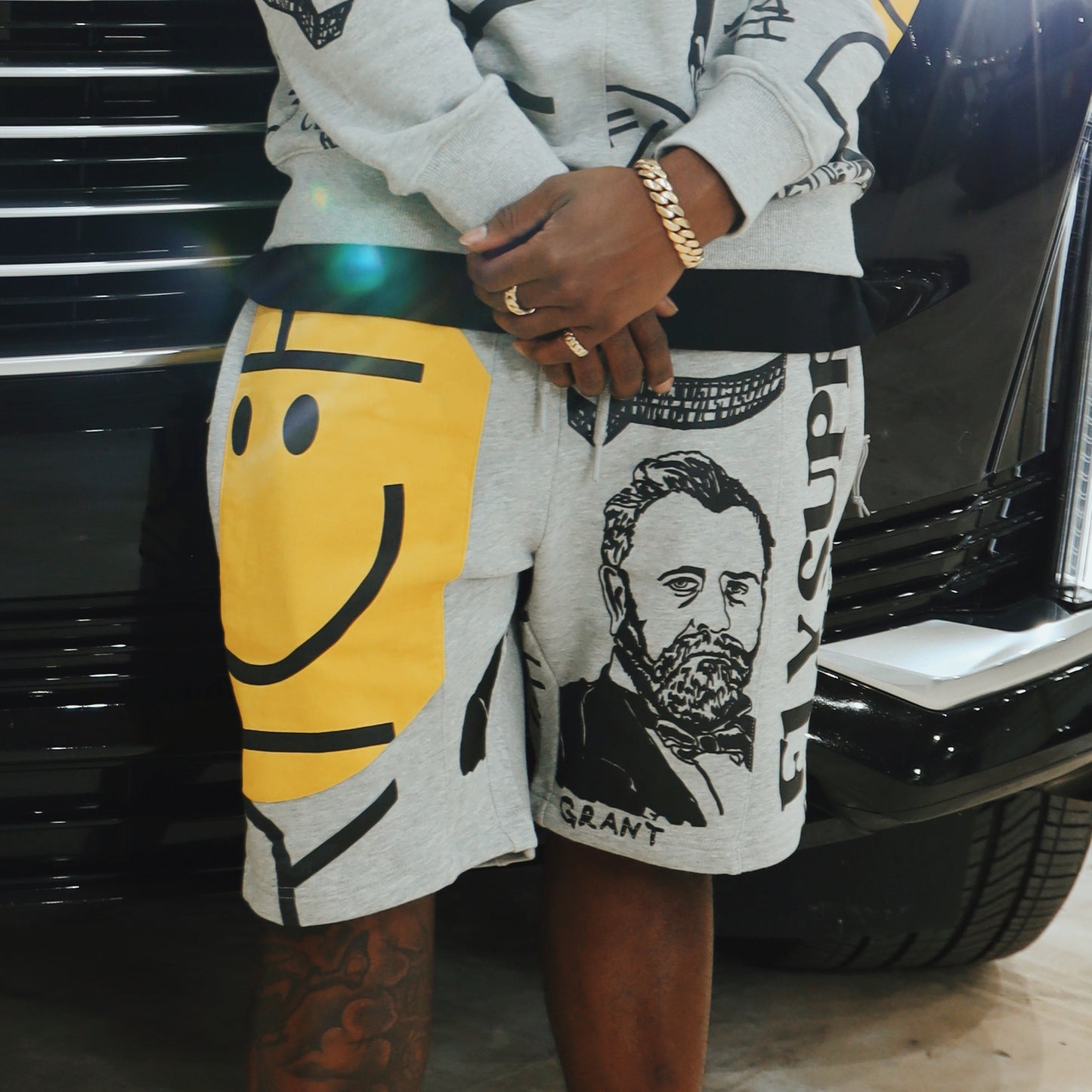 Graphic statement shorts featuring bold prints and a relaxed fit, styled against a sleek black vehicle.