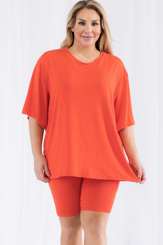 Plus size biker shorts set in vibrant orange featuring a loose fit top and biker shorts for comfort and style.