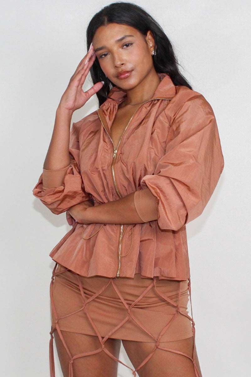 Desert Rose windbreaker skirt set featuring a cinched waist windbreaker and tassel skirt, displayed by a model.