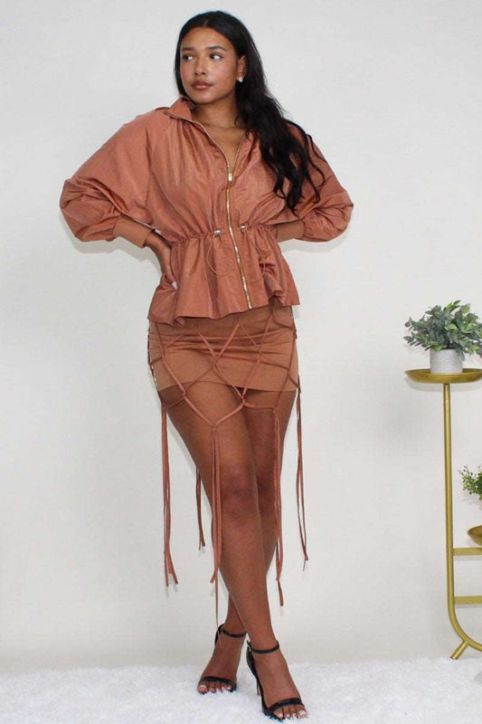 Desert rose windbreaker skirt set displayed on model with cinched waist.
