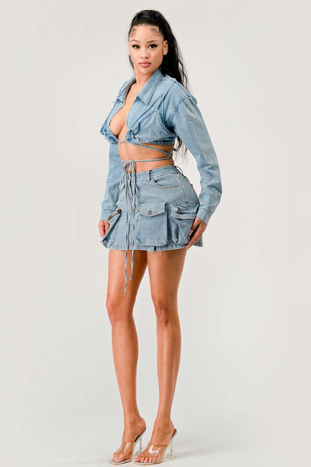 Model showcasing a cropped denim jacket with tie-front paired with a matching denim skirt.