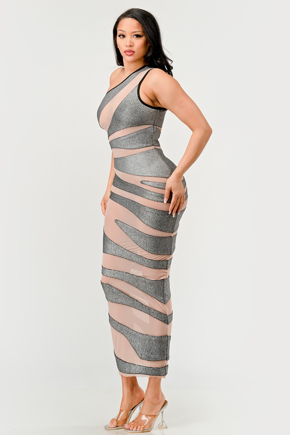 Model in a metallic bandage mesh dress with asymmetrical neckline and striking design.