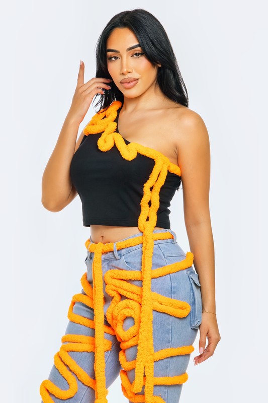 Asymmetrical crop top with contrast piping, featuring a one-shoulder design and vibrant orange details.