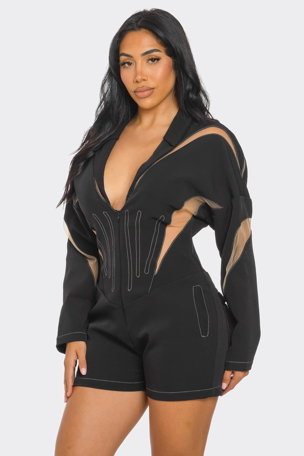 Chic mesh panelled black romper showcasing bold design details and a flattering fit.