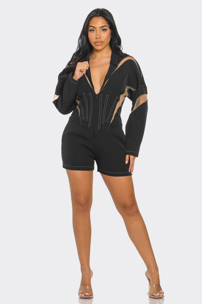 Chic mesh panelled black romper featuring a deep V-neck and stylish design detailing.