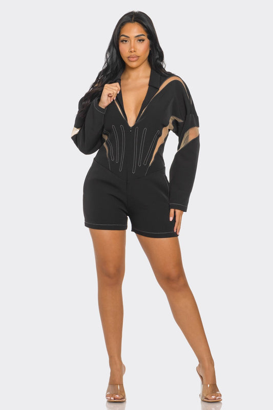 Chic mesh panelled black romper featuring a deep V-neck and stylish design detailing.