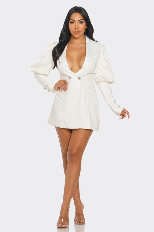 Model wearing an ivory blazer dress with puff sleeves and deep V-neckline, showcasing a stylish and elegant look.