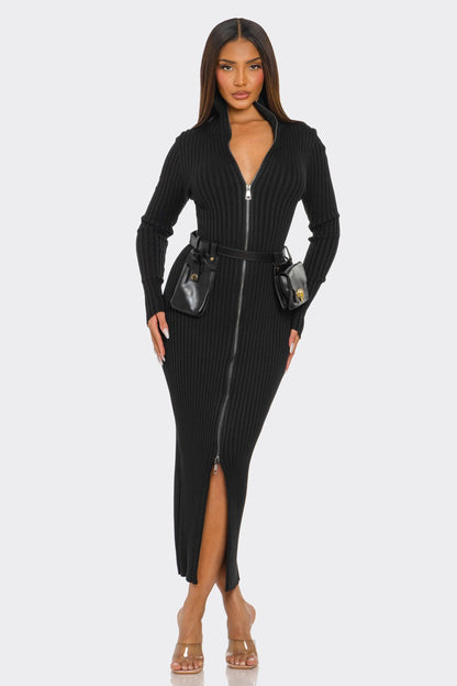 Model wearing a ribbed knit utility dress with front zipper and removable utility belt, showcasing modern style.
