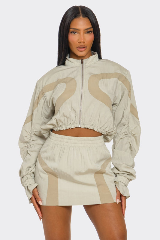 Two-tone windbreaker skirt set featuring a cropped jacket and mini skirt in lightweight fabric