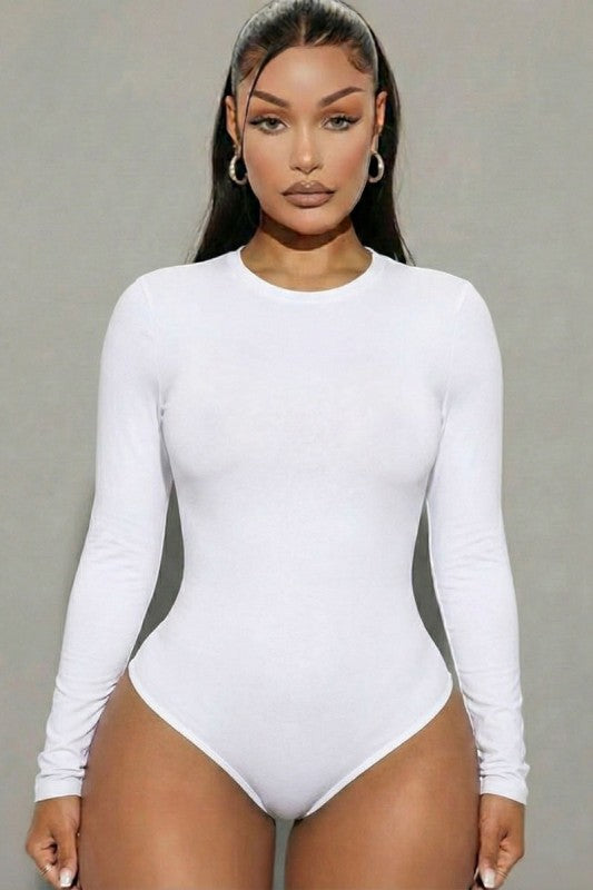 Model wearing a sleek solid long sleeve round neck bodysuit in white, showcasing a stylish and flattering fit.