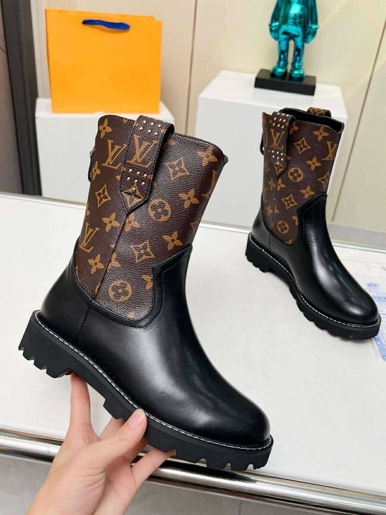monogram combat boots featuring sleek black leather and bold patterned detailing on a chunky sole.