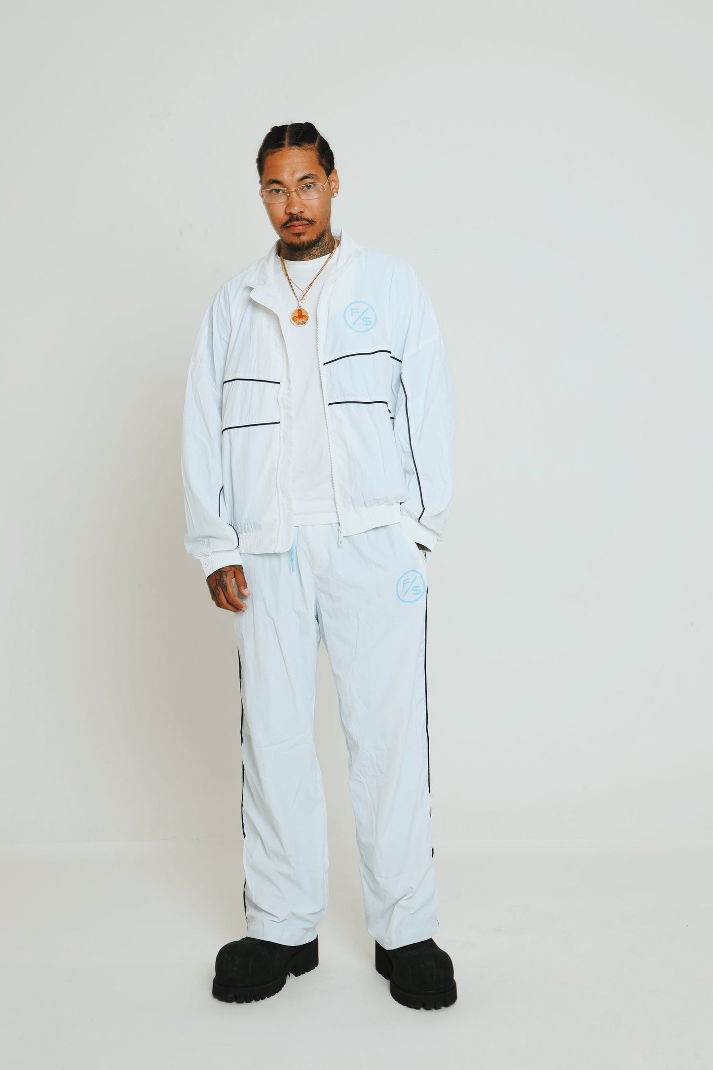 Lightweight utility track pants paired with a matching zip jacket in a modern streetwear style.