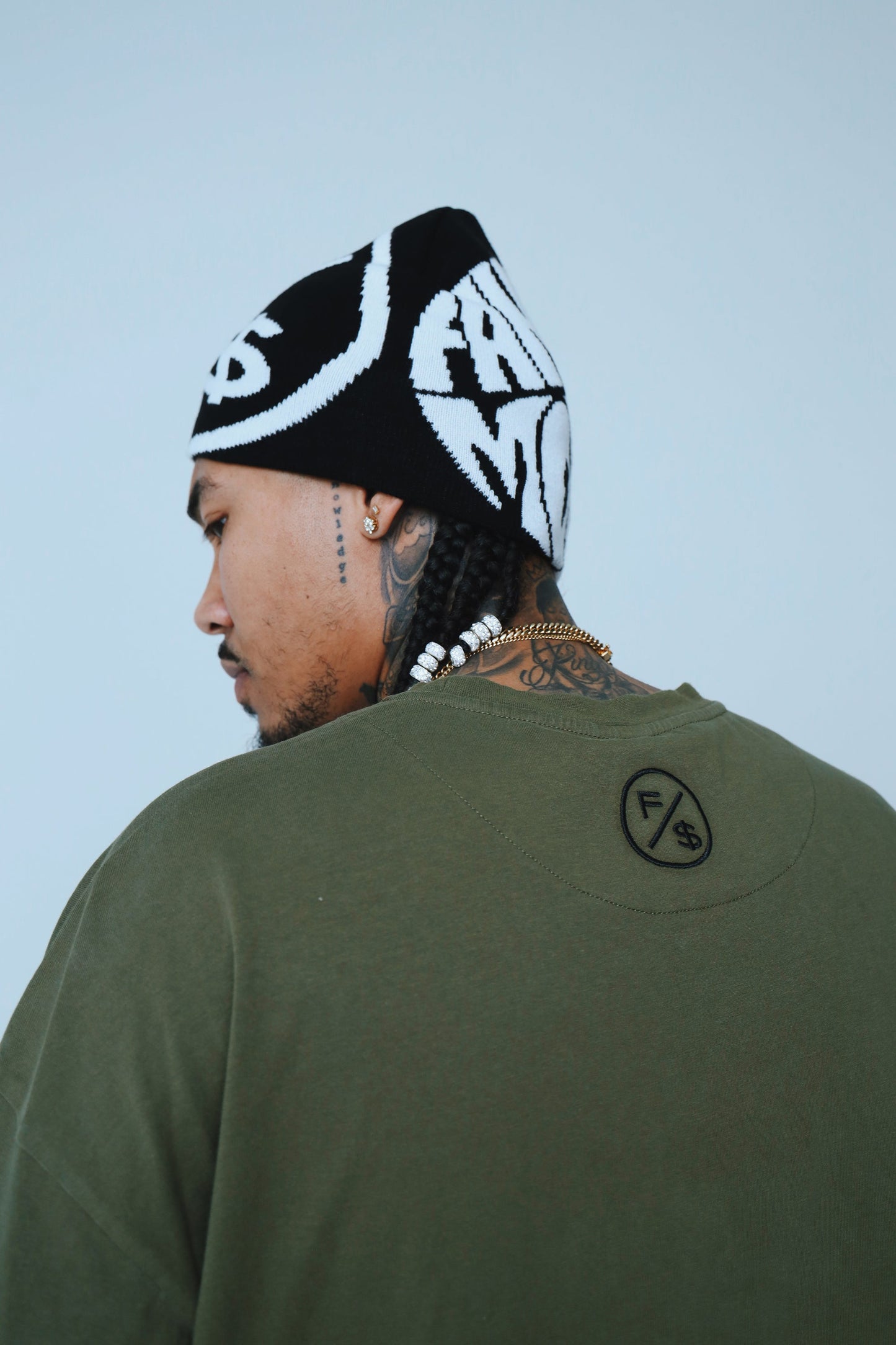 Oversized graphic t-shirt streetwear worn by a model, featuring a relaxed fit and a beanie.