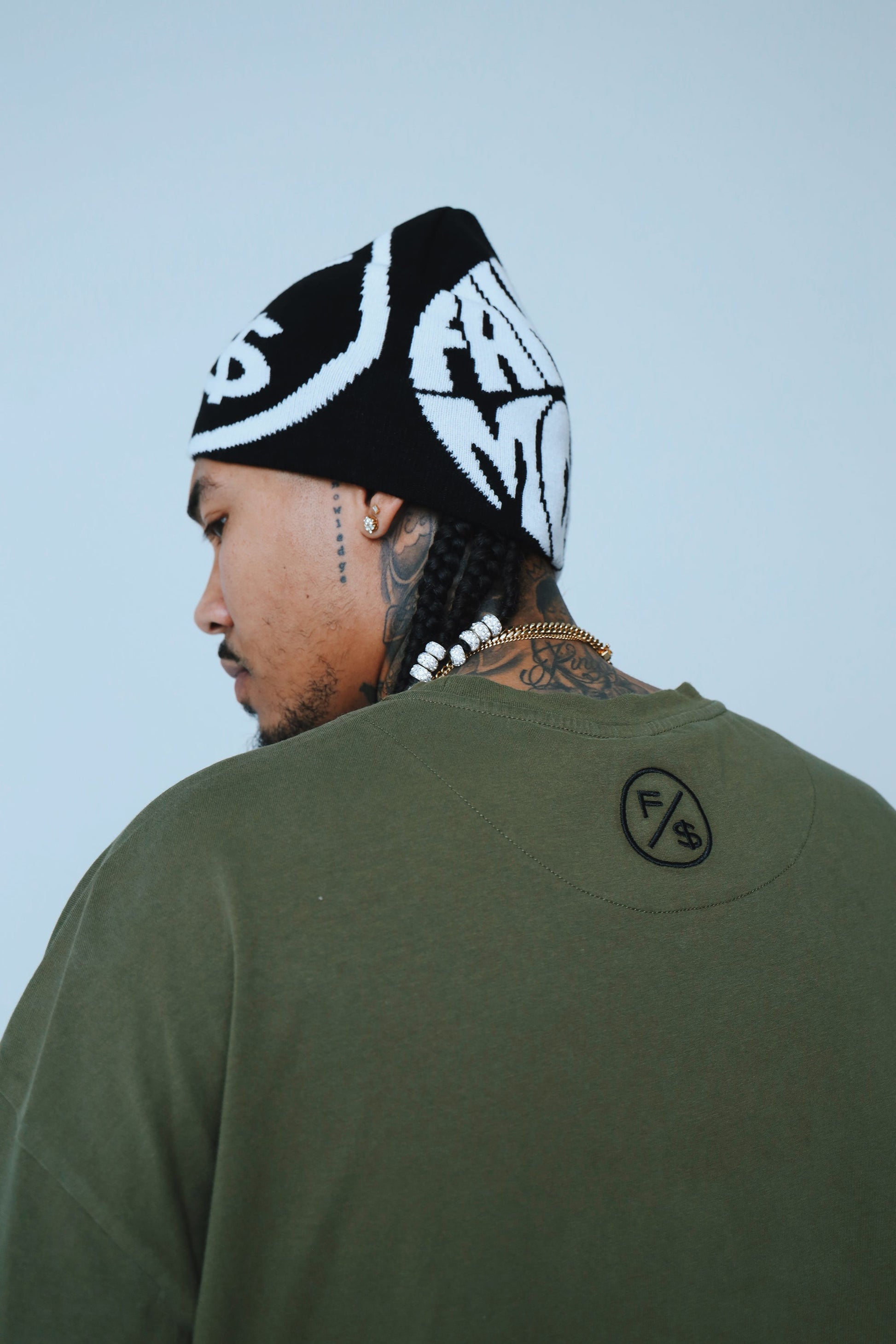 Oversized graphic t-shirt streetwear worn by a model, featuring a relaxed fit and a beanie.