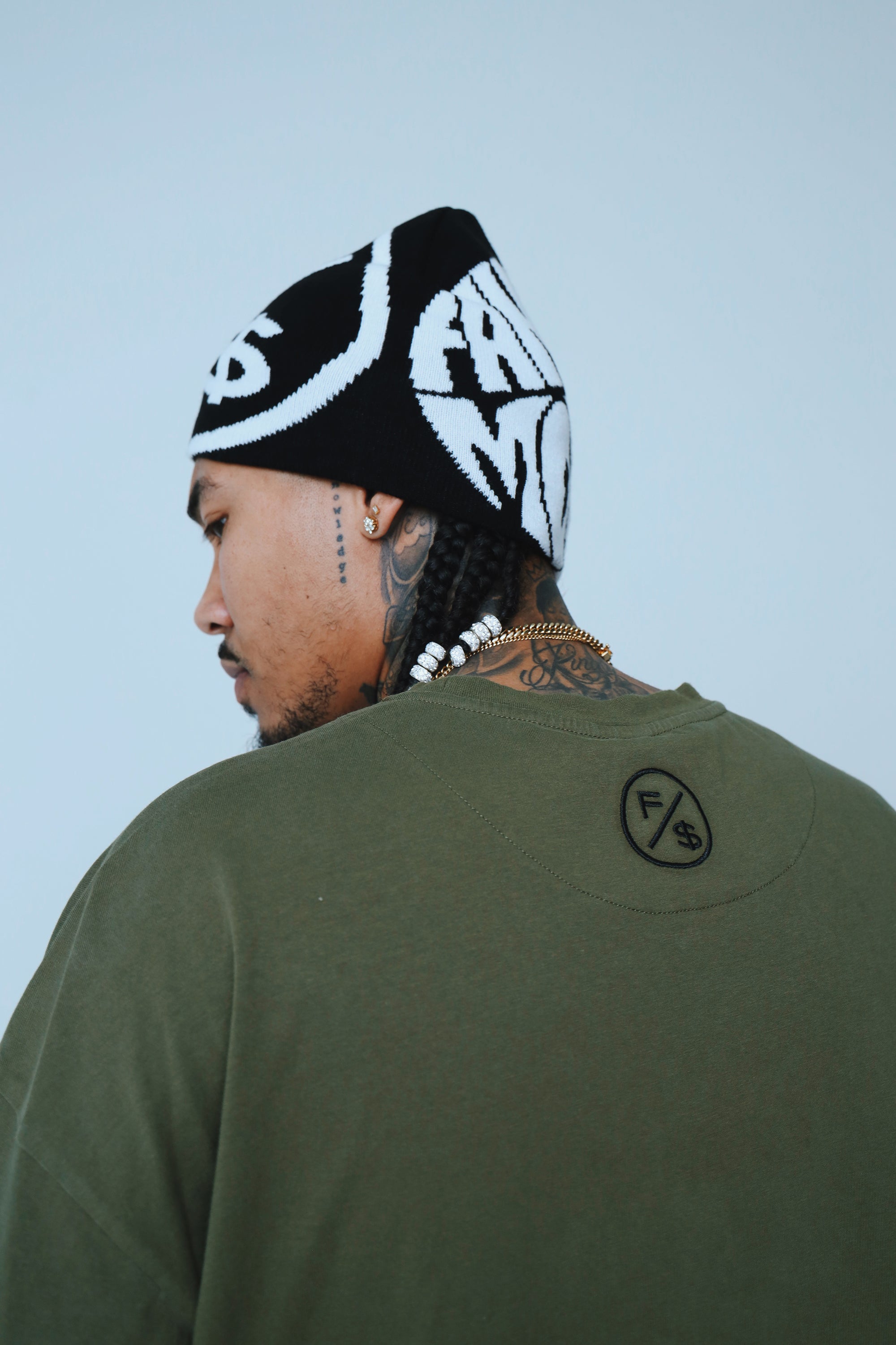Oversized graphic t-shirt streetwear worn by a model, featuring a relaxed fit and a beanie.