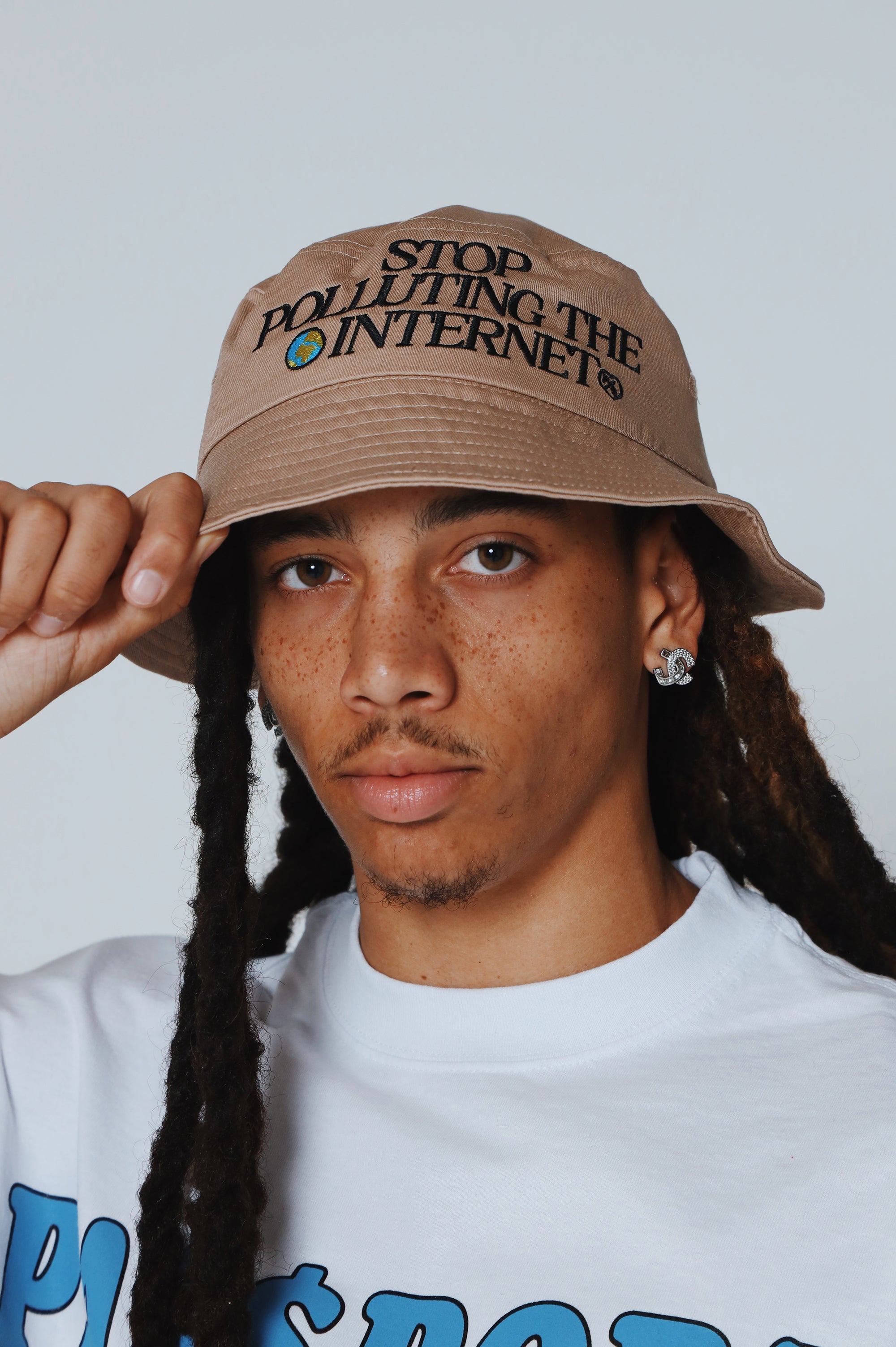 Unisex graphic statement bucket hat with 'Stop Polluting the Internet' design, worn by a model.