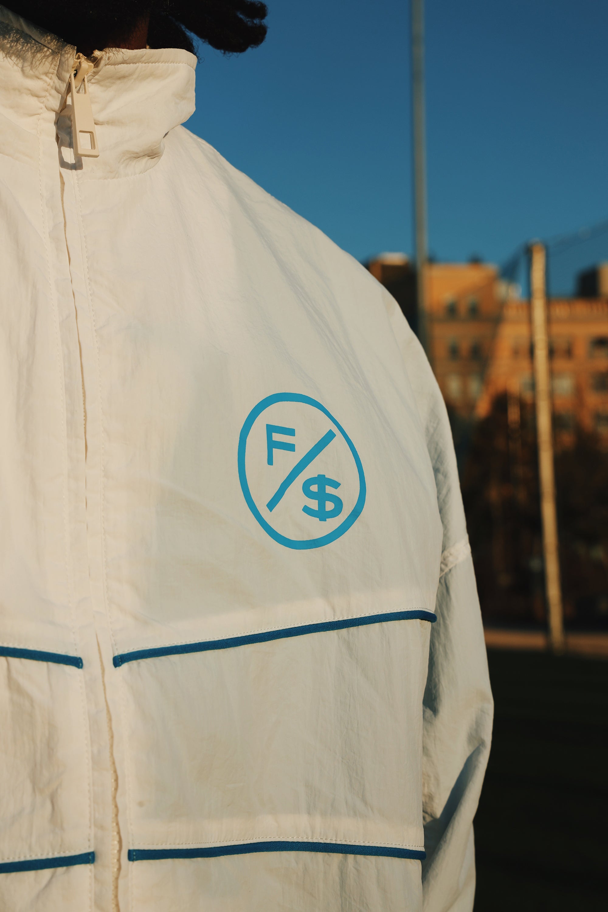Lightweight utility windbreaker jacket featuring a stylish logo design and modern full zip for streetwear fashion.