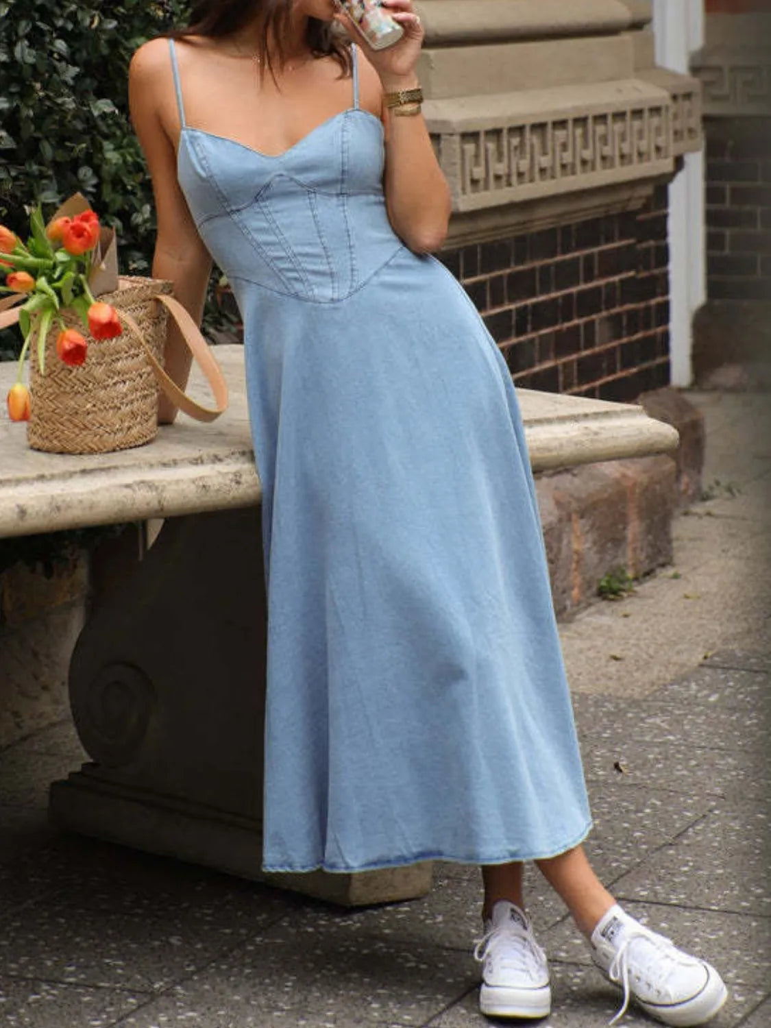 Smocked sweetheart neck midi dress in light denim, featuring spaghetti straps and a relaxed fit perfect for casual outings.