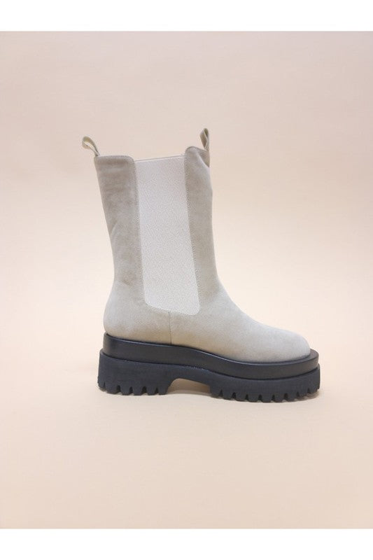 Slip-on platform combat boots featuring a modern design with a chunky sole and stylish neutral color.