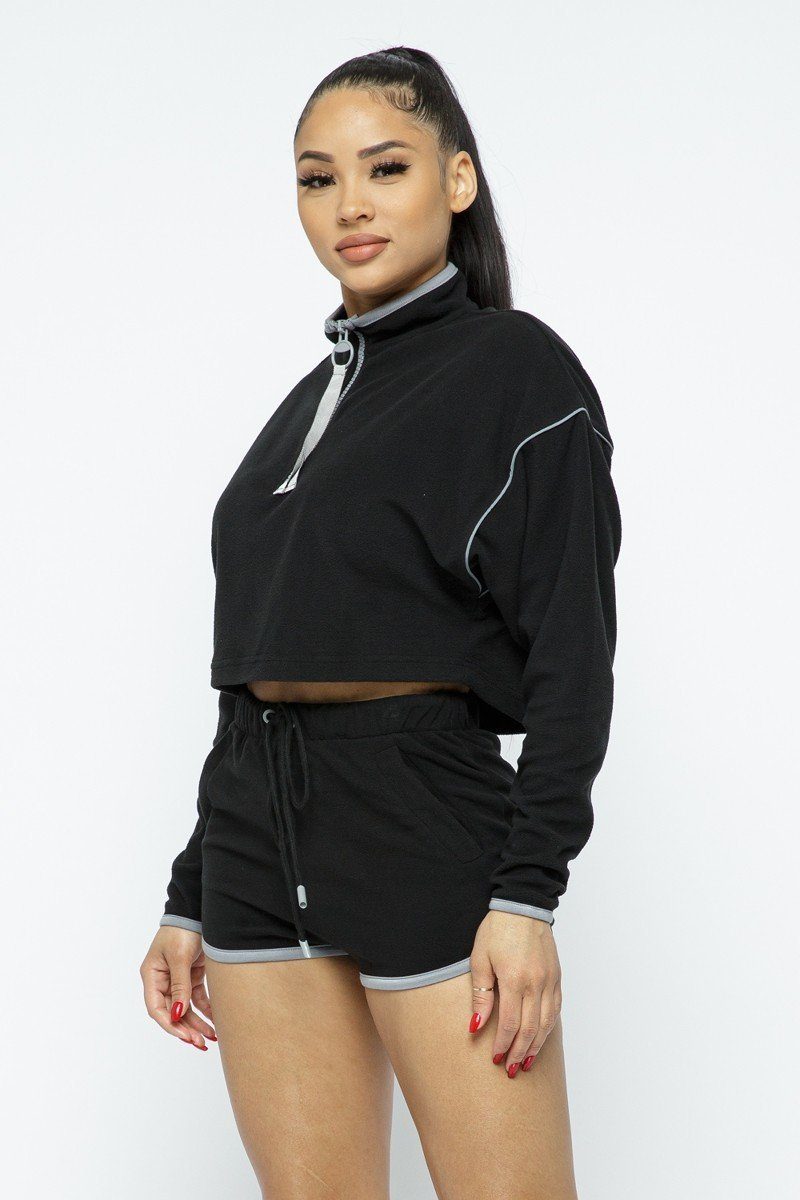 Sporty Crop Top and Shorts Set featuring a stylish cropped design and high-waist shorts with zipper details.
