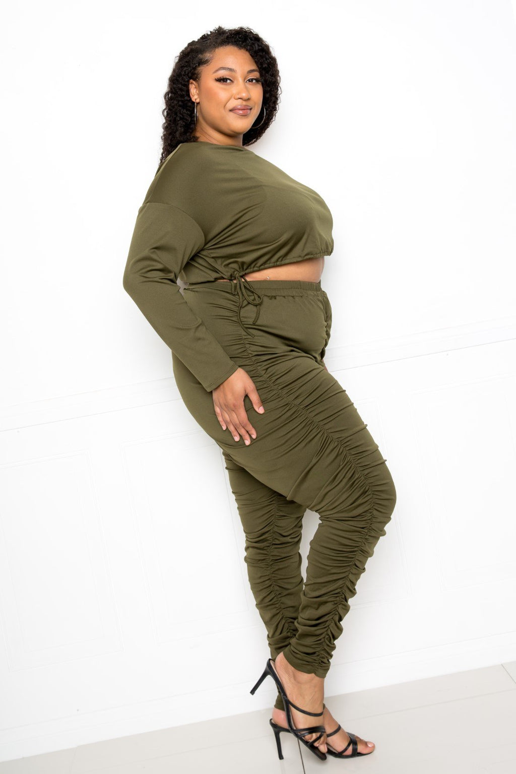 plus size off shoulder cropped top set featuring stylish ruched leggings in olive green.