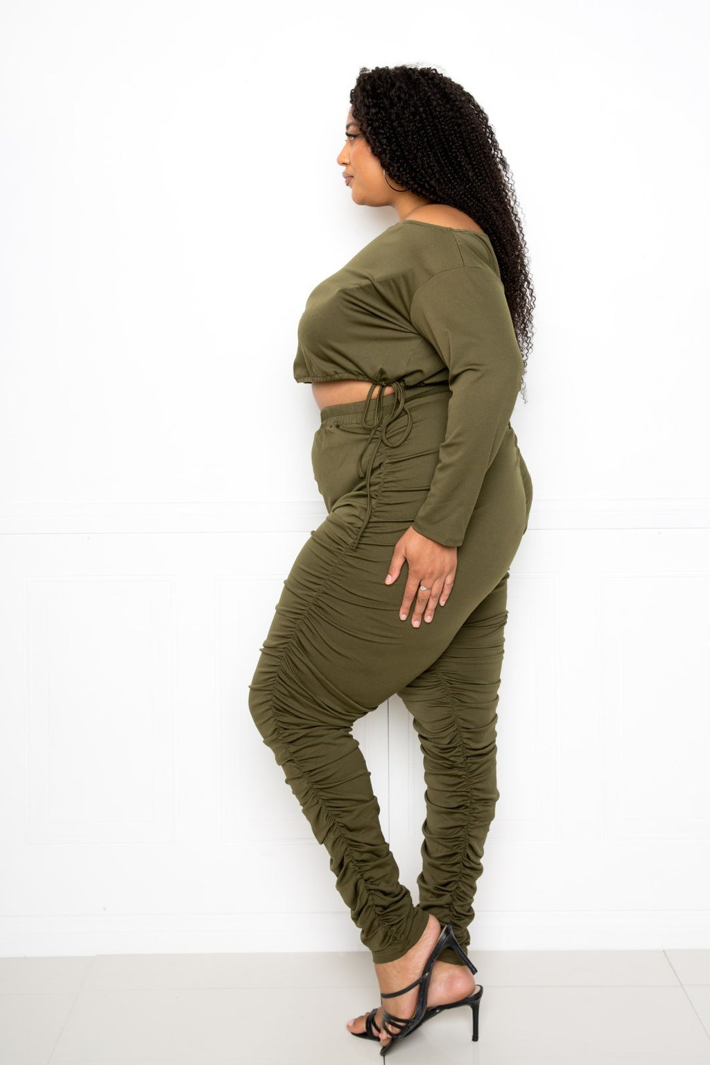 Plus size off shoulder cropped top set featuring ruched leggings, perfect for curvy figures in trendy olive green.
