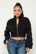 Model wearing Michelin sweater top with front zipper, showcasing cozy black knit design.