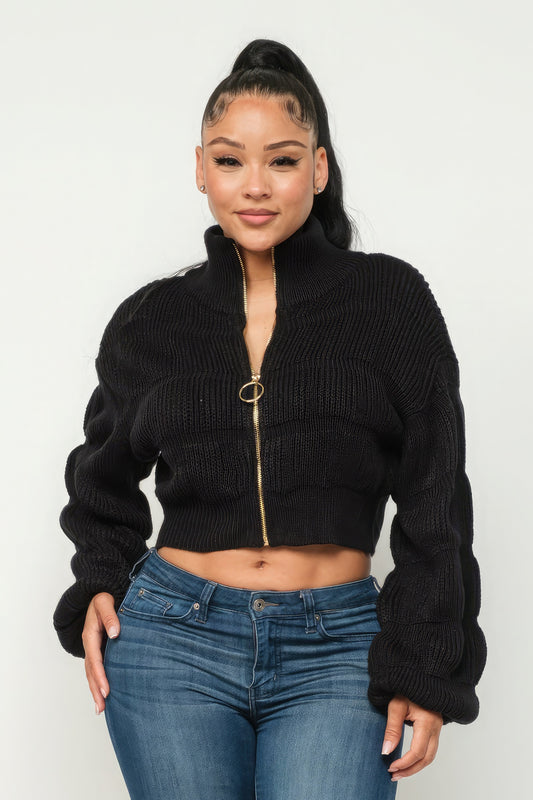 Model wearing Michelin sweater top with front zipper, showcasing cozy black knit design.