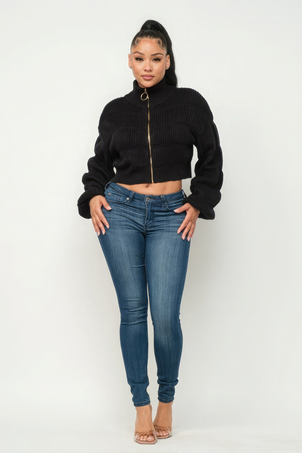 Michelin sweater top with front zipper paired with stylish jeans and heels on a model.