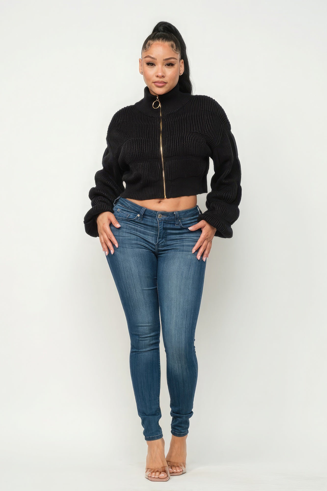Michelin sweater top with front zipper paired with stylish jeans and heels on a model.