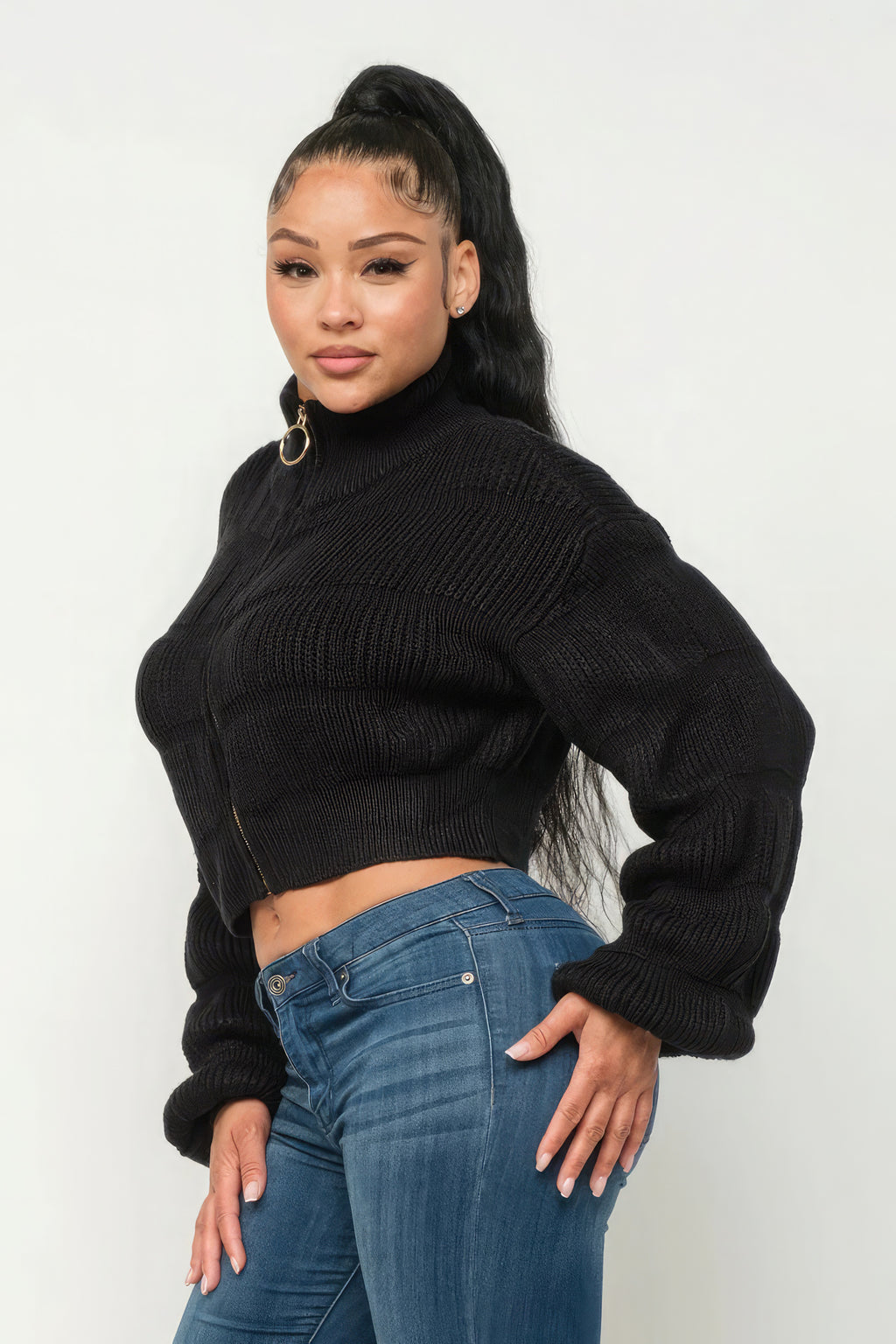 Model showcasing Michelin sweater top with front zipper in black, paired with blue jeans, stylish and modern look.