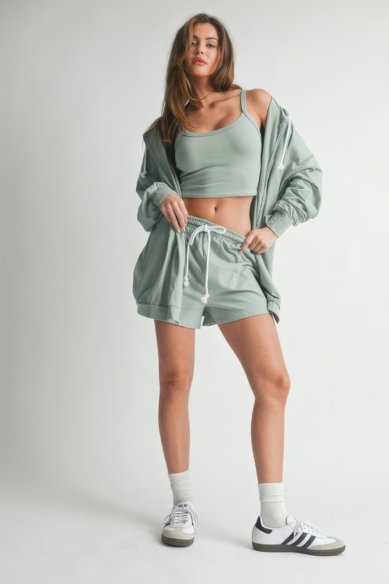 Rose cotton sweater set model showcasing stylish three-piece ensemble in soft green fabric.