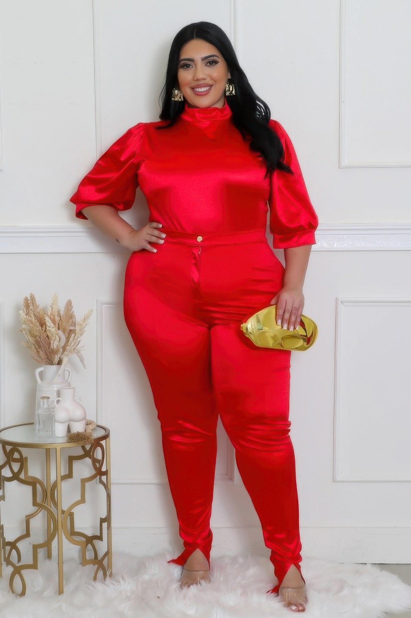 Elegant model showcasing a red bodysuit pants set, featuring satin finish and stylish design, perfect for any occasion.