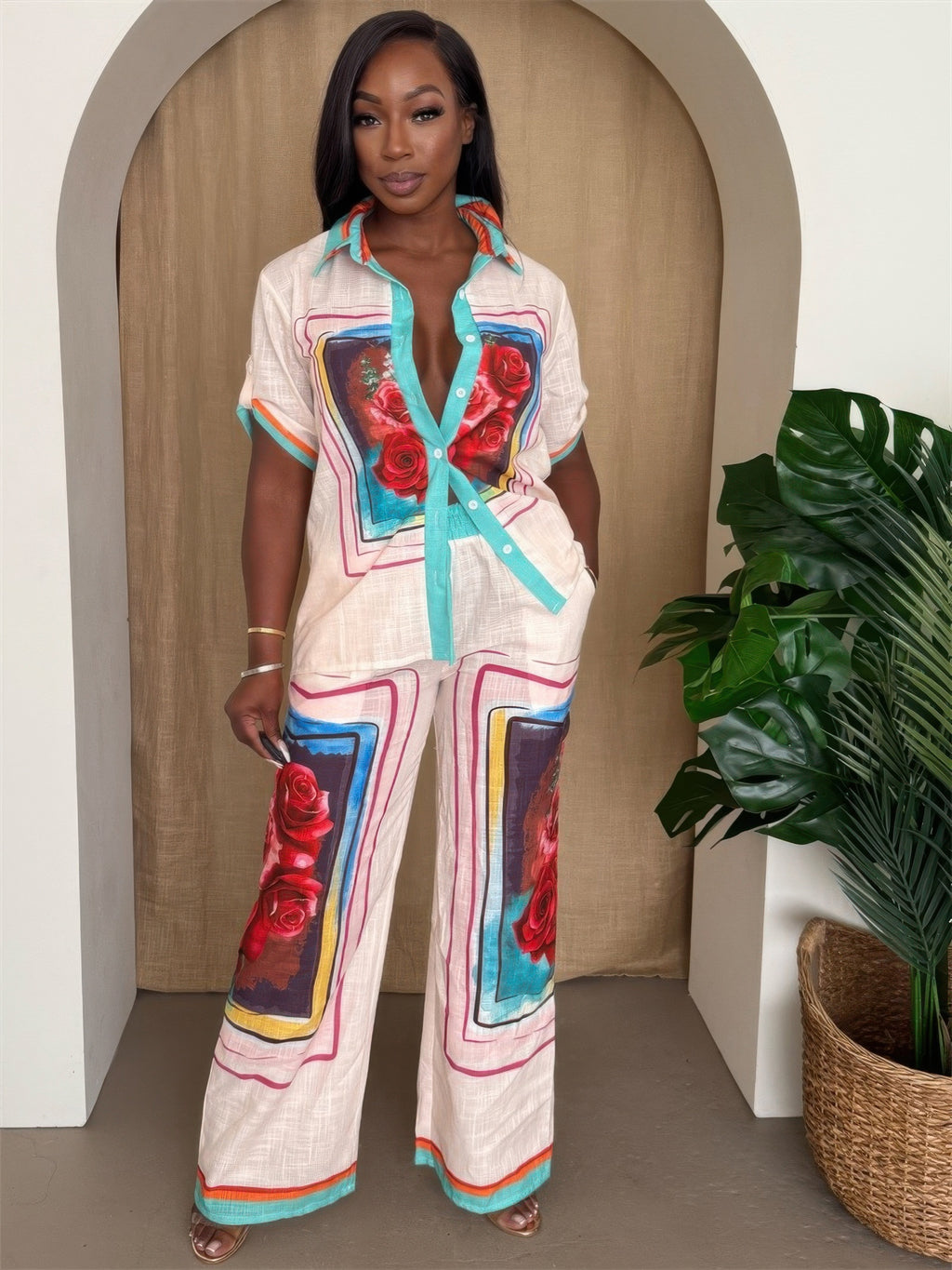 Model showcasing the Fresh Roses lounge set with vibrant rose prints and teal accents, perfect for casual or resort wear.