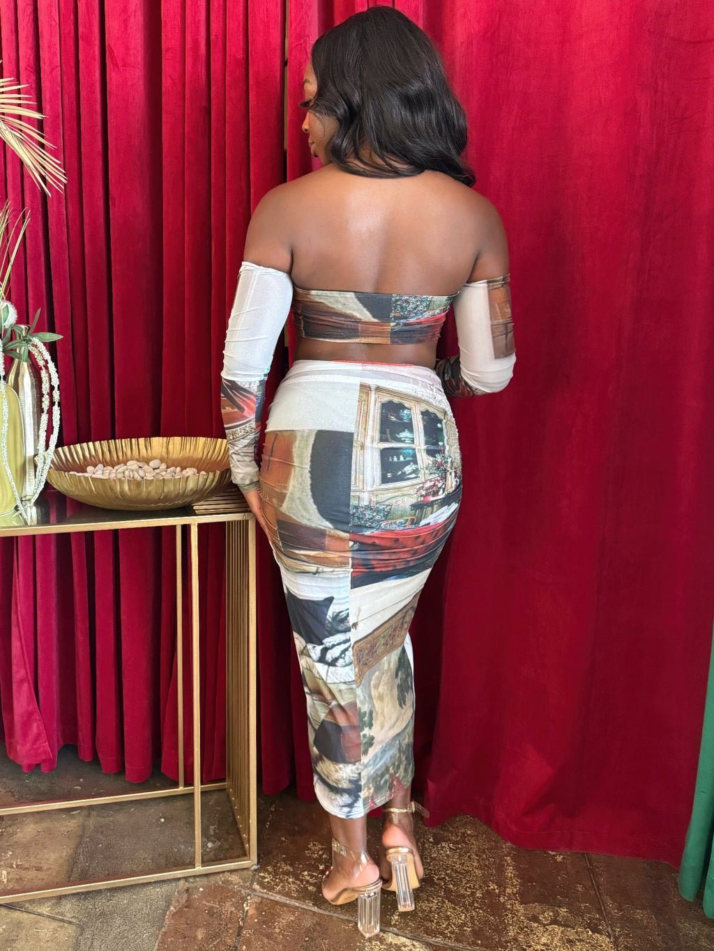 Back view of a woman in a Gallery Montage two-piece skirt set with artistic patchwork print.
