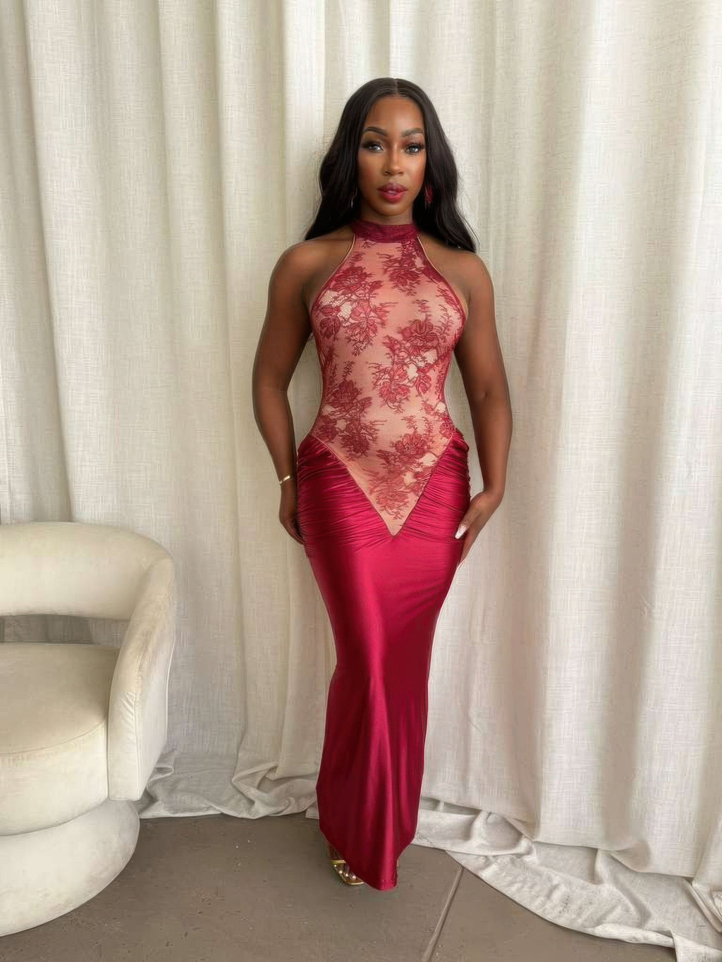Model showcasing the crimson lace hourglass dress with halter neckline and ruched satin skirt.