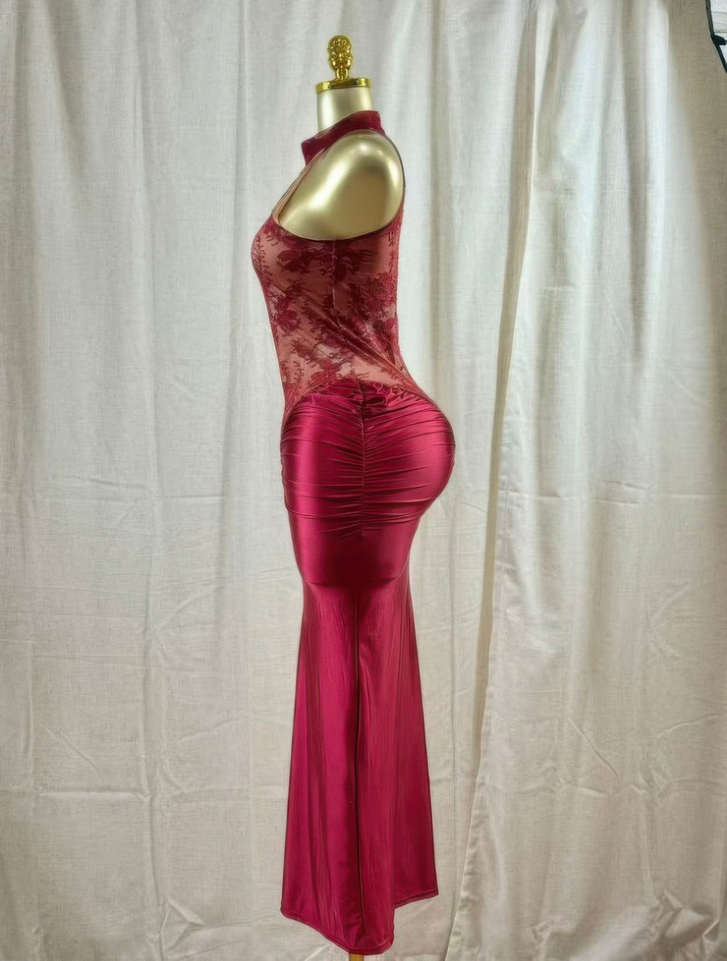 Crimson Lace Hourglass Dress on mannequin showcasing side view with halter neckline and ruched satin skirt.