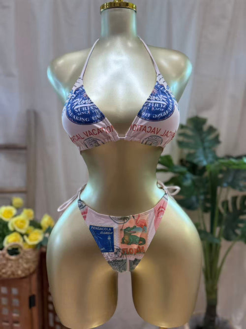 Vintage postcard bikini set displayed on a mannequin, featuring a triangle top and matching bottoms with retro postcard print.