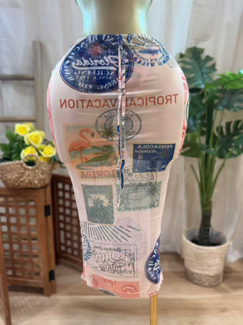 Sheer mesh midi skirt featuring vintage postcard-inspired print, perfect for beachwear styling.