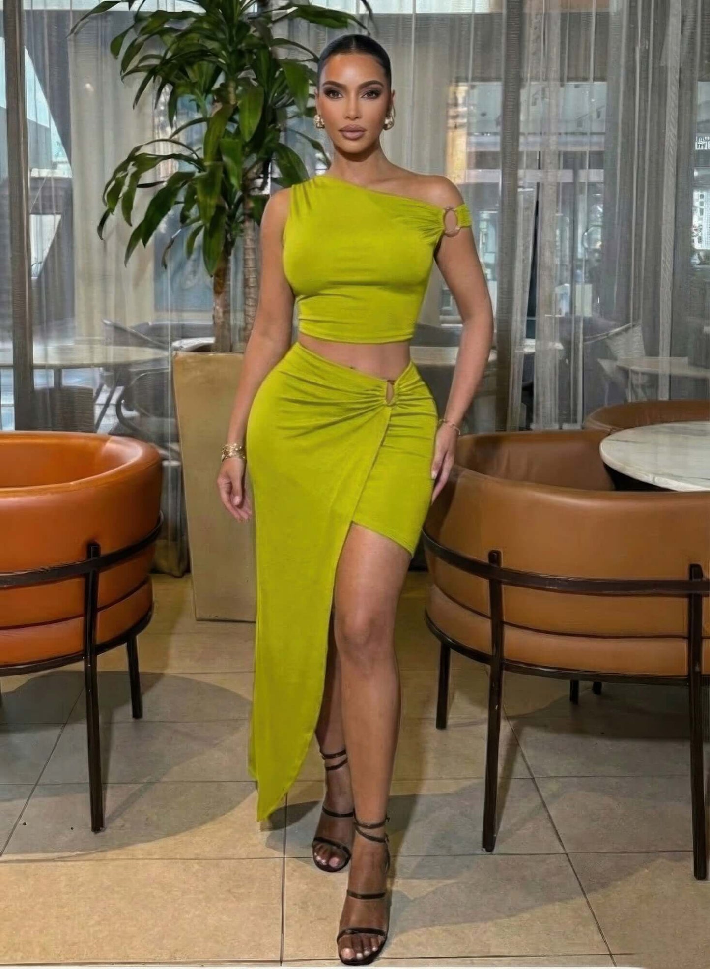 One Shoulder Crop Top & Maxi Skirt Set in lime green with gold ring detail, high-waisted maxi skirt and front slit, worn indoors
