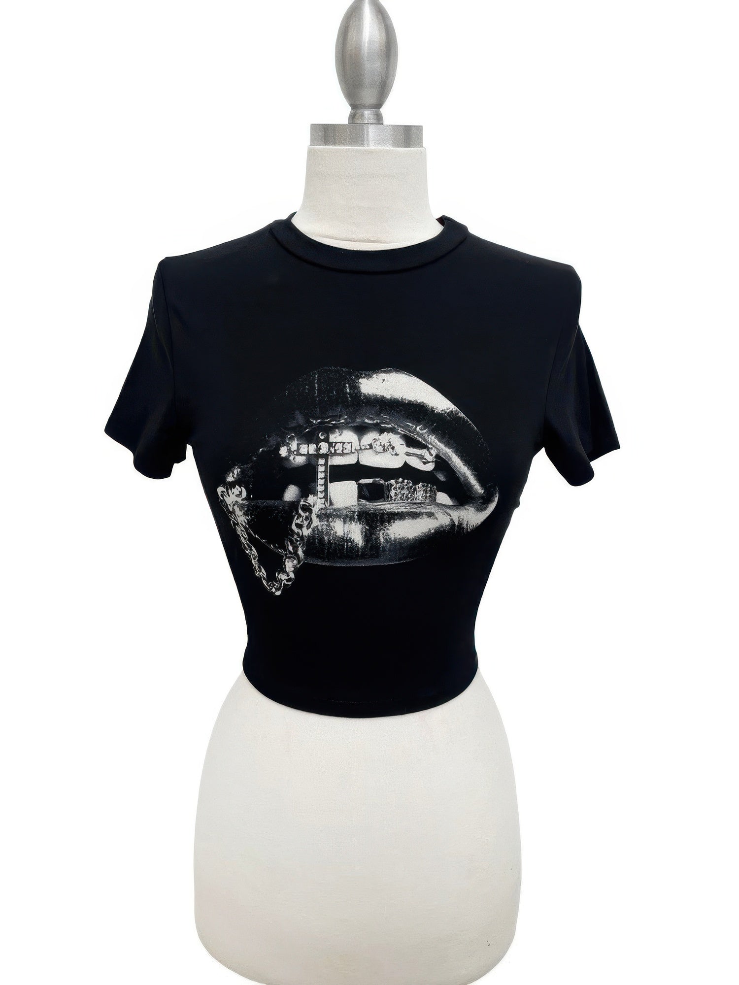 Alt Tag: Graphic Lips Crop Top black cropped tee with metallic silver lips graphic, short sleeves and crew neckline on mannequin