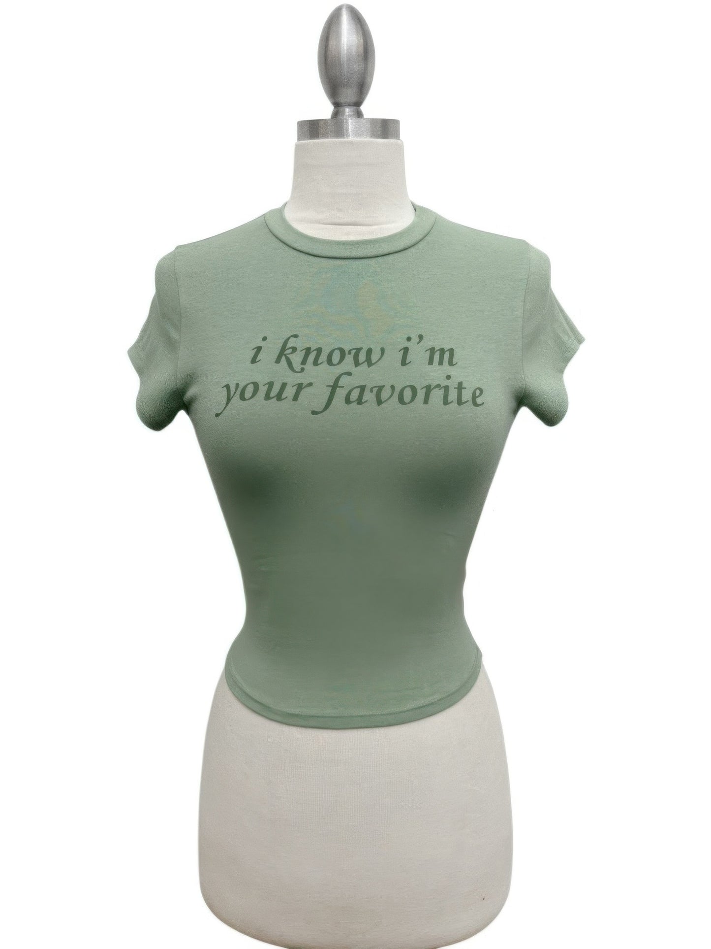 Alt Tag: Your Favorite Baby Tee sage green fitted cropped baby tee on mannequin with “i know i’m your favorite” graphic print
