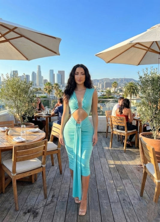 Alt Tag: Cutout Halter Bodycon Midi Dress in turquoise stretch jersey with front cutout and ruched detail, worn outdoors on a patio