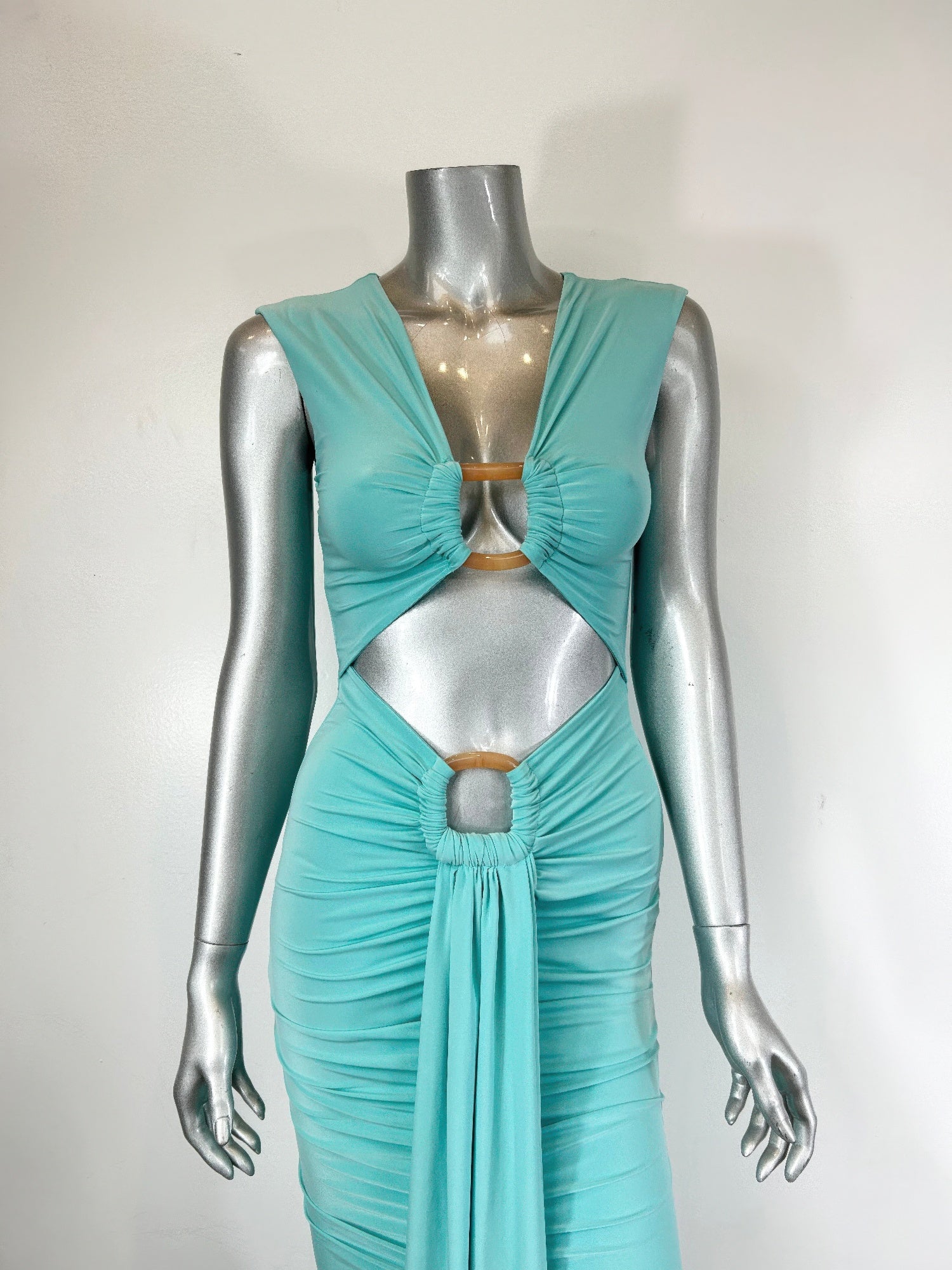 Alt Tag: Cutout Halter Bodycon Midi Dress in turquoise stretch jersey with front cutouts and ruched midi silhouette on mannequin